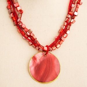 Cluster beaded necklace with large pendant in shades of pink & red by Mixit